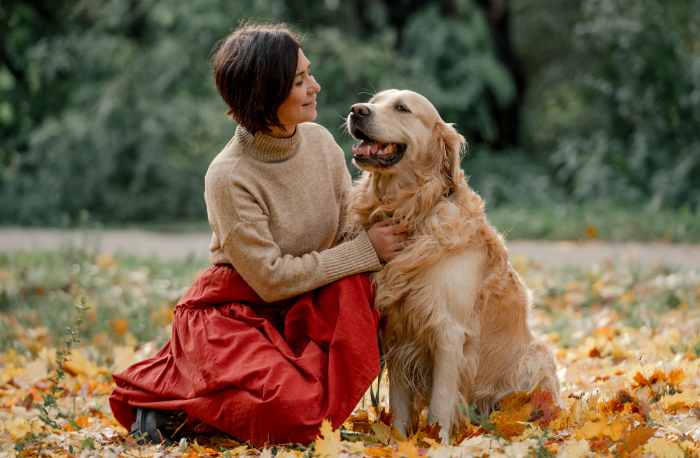 young woman outside with golden dog - pet friendly mental health treatment facility in orange county